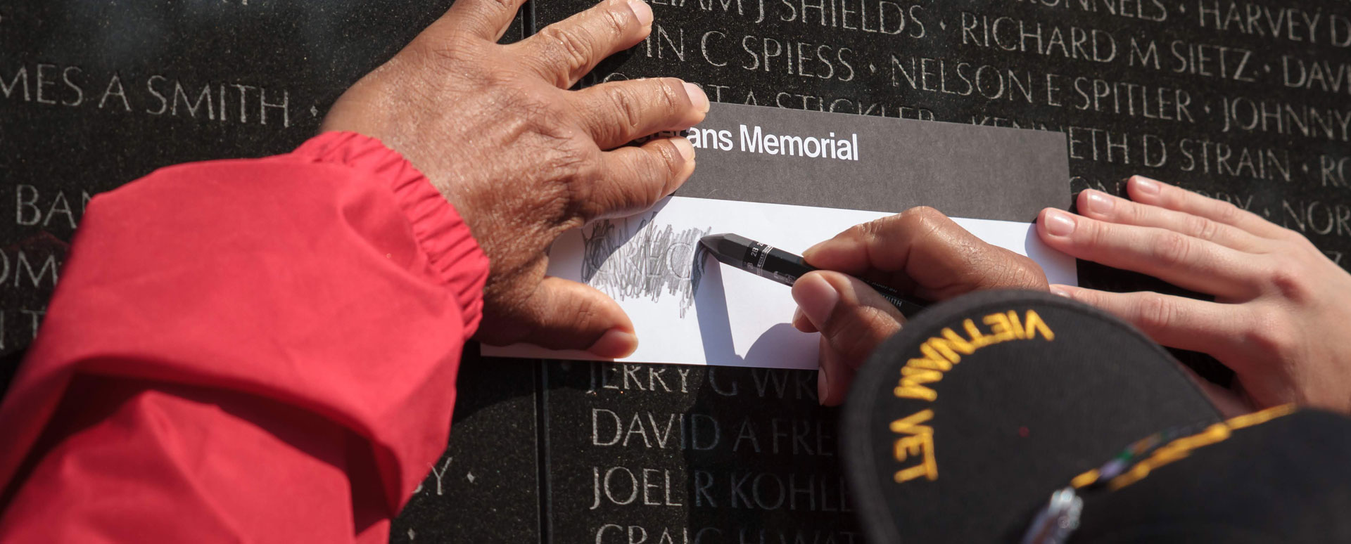 Vietnam Vet Creating a Rubbing on the Vietnam Wall